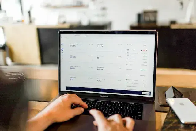 Someone reviewing affiliate revenue on a laptop